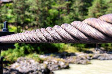 Fototapeta premium Detailed perspective view of steel cable and chain. Bridge and industrial construction technology