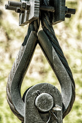 Shabby golden cable and rope fastening system with iron loop and hook. Bridge and industrial construction technology