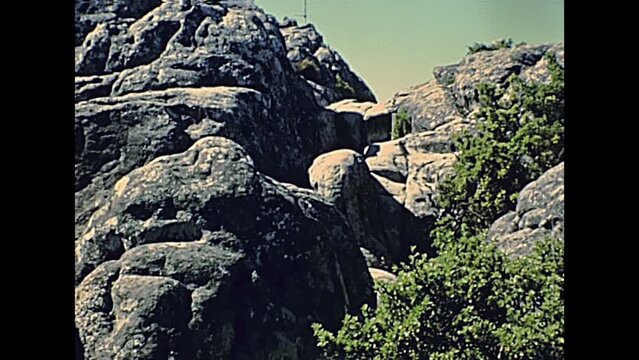 CAPE TOWN, South Africa - CIRCA 1980: tourists visiting Table Mountain nature reserve, top of the mountain with old buildings. Historical archival footage in Cape Town city of South Africa in 1980s.