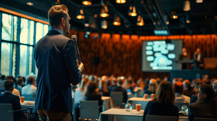 Engaged Audience at a Business Seminar Featuring Industry Experts on a Professional Stage Setup