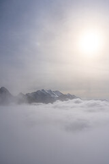 View of Swiss Alps over clouds on a bright sunny day from Schilthorn summit in Switzerland