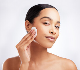 Studio, portrait and woman with cotton for skincare, makeup removal and cleansing for wellness. Female model, cosmetics and products for cleaning, facial treatment and swab pad by white background - Powered by Adobe