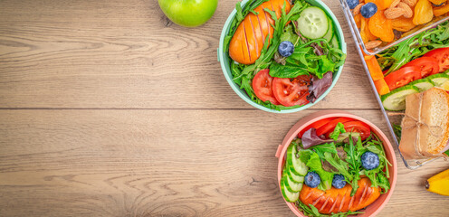 Lunch box, snacks on wooden background, concept of vacation nutrition, tourism, healthy snack