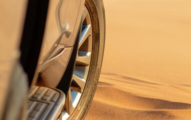 Close up of a golden car stuck in the sand in the Namib desert. 