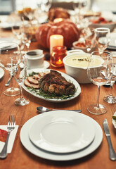 Thanksgiving, dinner and food on table in home for fine dining party, celebration and family or social event. Cooking, supper and feast, meat and gourmet meal for holiday, festive eating and lunch