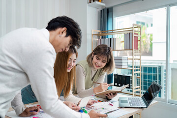 Obraz premium Creative Team collaboration on UX UI Design Project in Modern Office Environment with Digital Devices and Design Tools