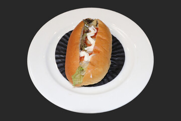 A mini sandwiches on a white plate lined with black baking paper