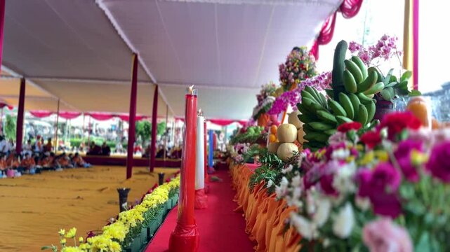 Vesak day procession with many flowers and burning candles, motion view
