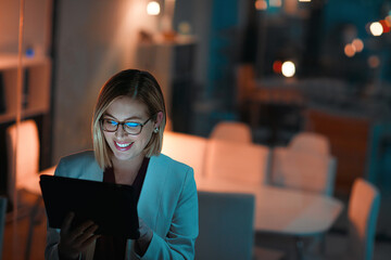 Business woman, tablet and typing with smile in office for corporate communication, internet research and networking. Female person, tech and working late night for project planning and email