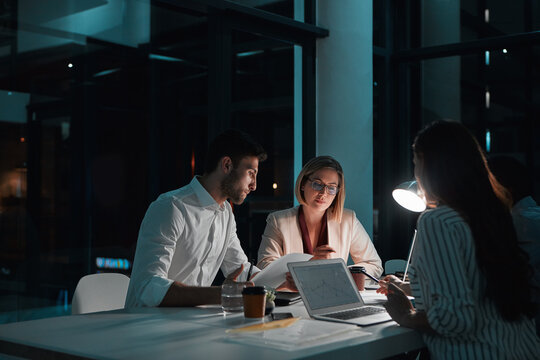 Teamwork, people and laptop in office at night with documents for deadline or overtime as accountant. Employee, partner and information for financial reviews, records and auditing in business report