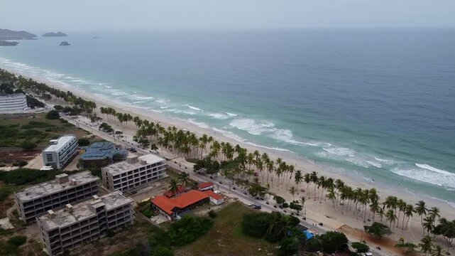 Aerial view of many motorcycle riding on coastal road in Venezuela. Beneficiary event against prostate cancer awareness along beach playa el agua, Venezuela.