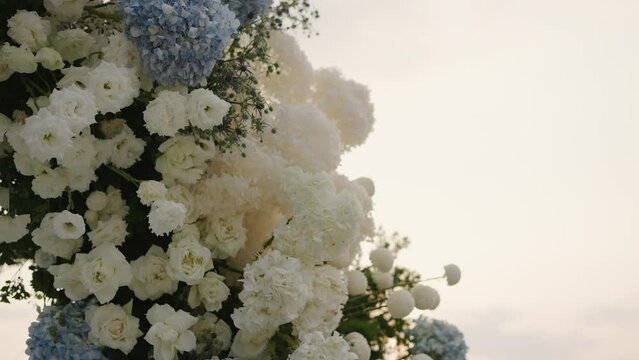 Decorative arch for the wedding ceremony Close-up of wedding arch decorated with flowers, roses,  outside wedding ceremony.