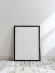 blank black poster frame on light wooden floor, empty picture frame mockup, blank vertical frame