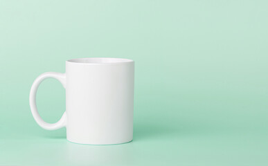 white cup for tea or coffee on a green background