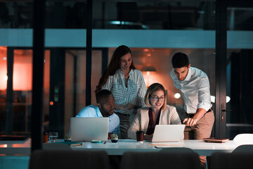 Research, laptop and business people in office at night with stock market charts for corporate...