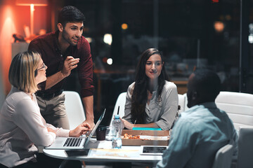Business people, laptop and problem solving for project at night in office, creative agency and overtime food for design. Teamwork, support and planning in pizza meeting for deadline and discussion