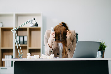 Asian woman feeling migraine head strain.Overworked businesswoman financier while working