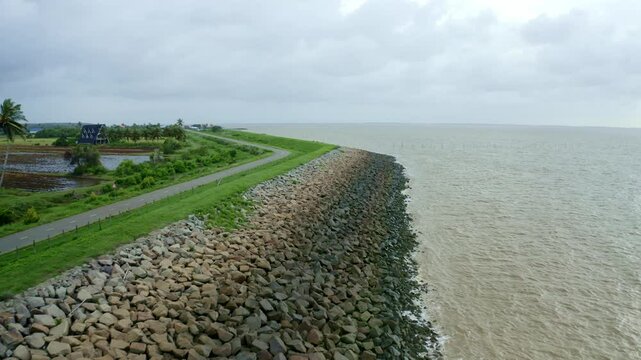 Aerial: Sea dyke view along the road flyover with North Atlantic Ocean and Nickerie Suriname