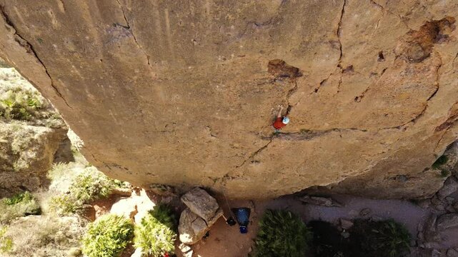 Man rock climbing aerial view of sportsman rapelling mountain in La Panocha, el Valle Murcia, Spain woman rapel down a mountain climbing a big rock