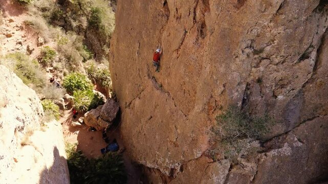 Man rock climbing aerial view of sportsman rapelling mountain in La Panocha, el Valle Murcia, Spain woman rapel down a mountain climbing a big rock