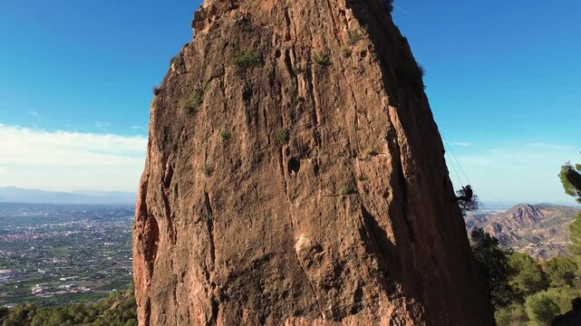 Man rock climbing aerial view of sportsman rapelling mountain in La Panocha, el Valle Murcia, Spain woman rapel down a mountain climbing a big rock