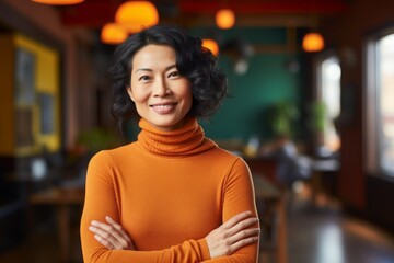 Fototapeta premium Portrait of a happy asian woman in her 40s wearing a classic turtleneck sweater isolated on vibrant yoga studio background