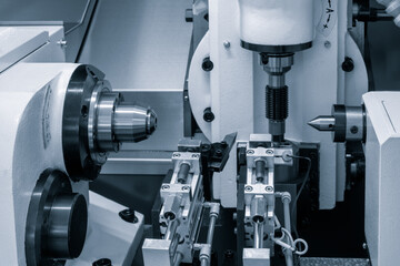 A machine with a white and black color scheme. The machine is used for cutting and shaping metal