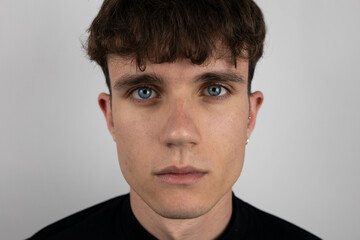 Fototapeta premium White background portrait in studio of young man.