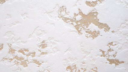 The wall is covered in white paint with a textured surface. The texture gives the wall a unique and interesting appearance