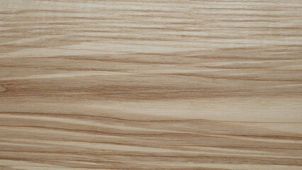 Naklejka premium A wooden surface with a grainy texture background. The wood appears to be aged and has a natural, rustic feel to it. The grain of the wood is visible in the image