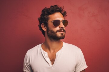 Fototapeta premium Portrait of a blissful man in his 30s wearing a trendy sunglasses on pastel or soft colors background