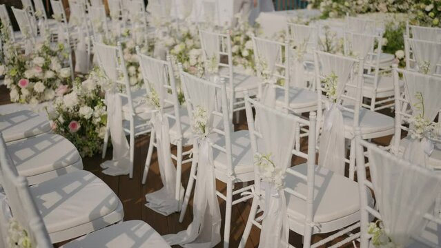 Wedding decoration chairs  White plastic Chiavari chairs in rows. Outdoor wedding ceremony, event, seminar or party with no people.