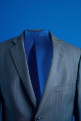 A headless mannequin dressed in a business suit against a blue background, ideal for business, marketing, and corporate-themed projects.