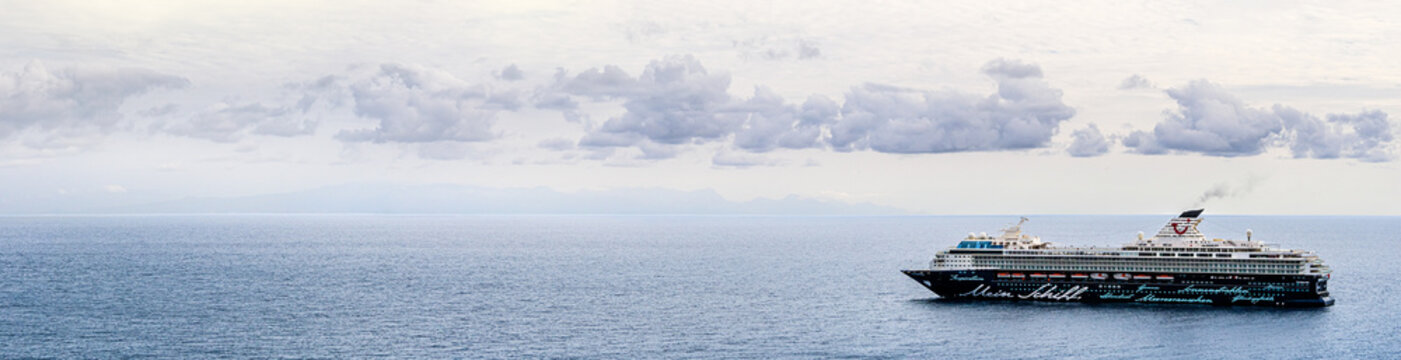 Tenerife, Canary islands, Spain - November 11, 2021: Passenger ship 'Mein Schiff Herz' of cruising travel company TUI in Atlantic Ocean, panoramic view. Sea voyage near the coast of Canary Islands.