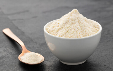 Organic gelatin powder also called hydrolyzed collagen - White powder in the bowl and spoon