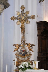 Golden crucifix and angels decorating a church, symbol of faith and devotion in christianity