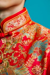 Close-up of a vibrant red traditional Chinese garment adorned with intricate gold embroidery, showcasing cultural elegance and craftsmanship.