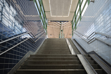 Obraz premium pedestrian stairs from the underpass to the train station, urban life