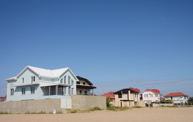 Luxury houses on a sandy beach near the sea