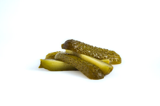 pile of cucumber dill pickle cut into spears, isolated on white background