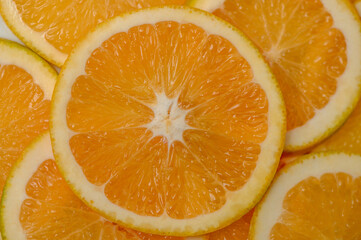 Sliced orange circles, laid on the surface in several layers. Tropical background for design and web 1