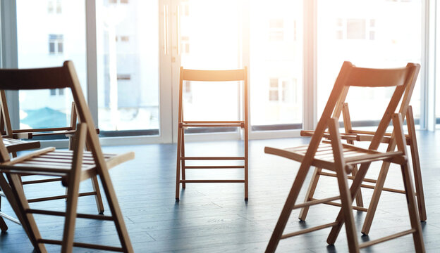Group, therapy and circle of chairs in empty room for counseling, rehabilitation or AA meeting. Psychology support, furniture and community centre for consultation, mental health or team building