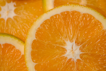 The background is orange slices. Orange is a delicious and healthy tropical fruit