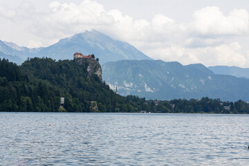 Panoramic view from Lake Bled, beauty heritage in Slovenia. Island with church and castle in the background create a dream setting. View from Ojstrica and Mala Osojnica with the heart-shaped bench.