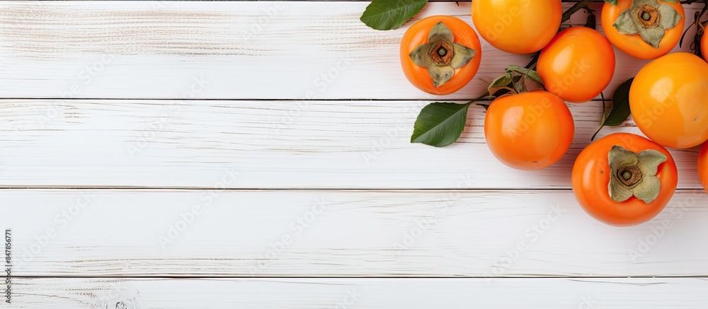 Poster healthy diet concept fresh ripe persimmons and tangerines on white wooden background top view flt la