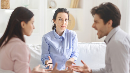 A young couple and a lady counselor engage in a meaningful therapy session, focusing on emotional...
