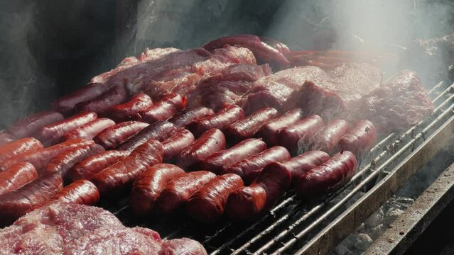 Traditional Spain Barbecue with various cuts of meat, ribs, sausages.