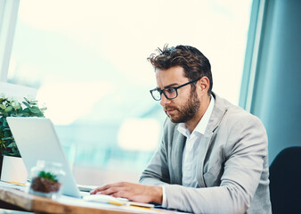 Businessman, accountant and office typing with laptop for planning, strategy or review in workplace. Male person, reading and computer for finances, updates or professional in corporate industry