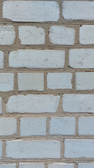 A white brick wall with an aged texture with scratches for background