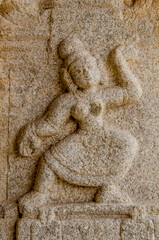 Stone bas-reliefs of a dancing women on the walls of Lord Krishna Temple in Hampi.  Unesco World Heritage Site. The famous tourist destination. Karnataka, India.